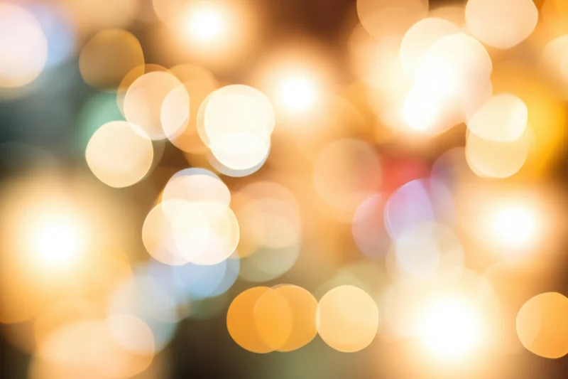Blurred warm glowing orbs arranged in soft bokeh pattern as background
