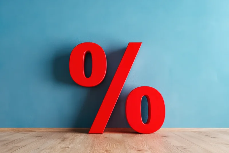 Bold red percentage symbol leaning against a blue wall on a wooden floor