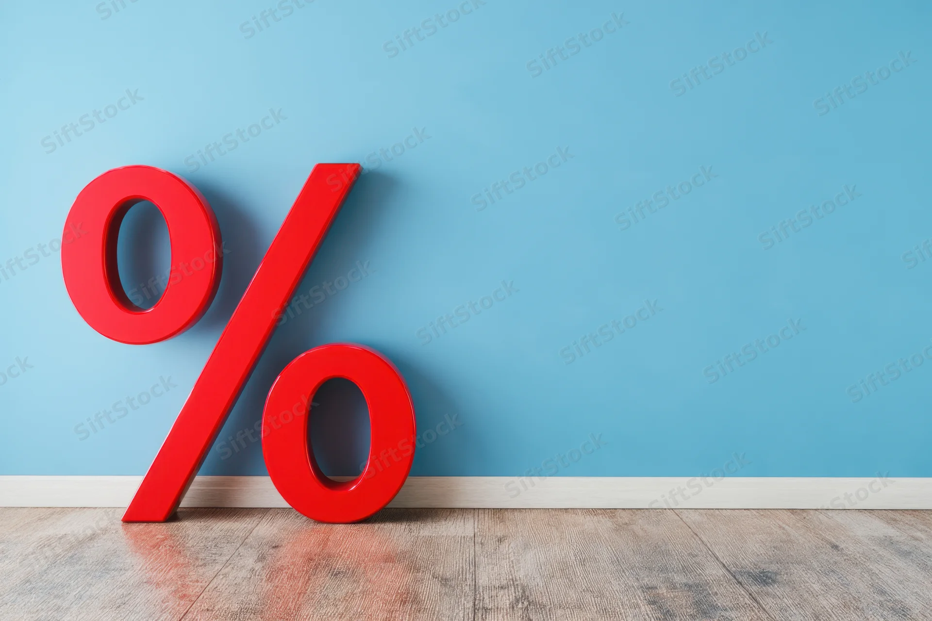 Red percentage symbol leaning against blue wall on wooden floor