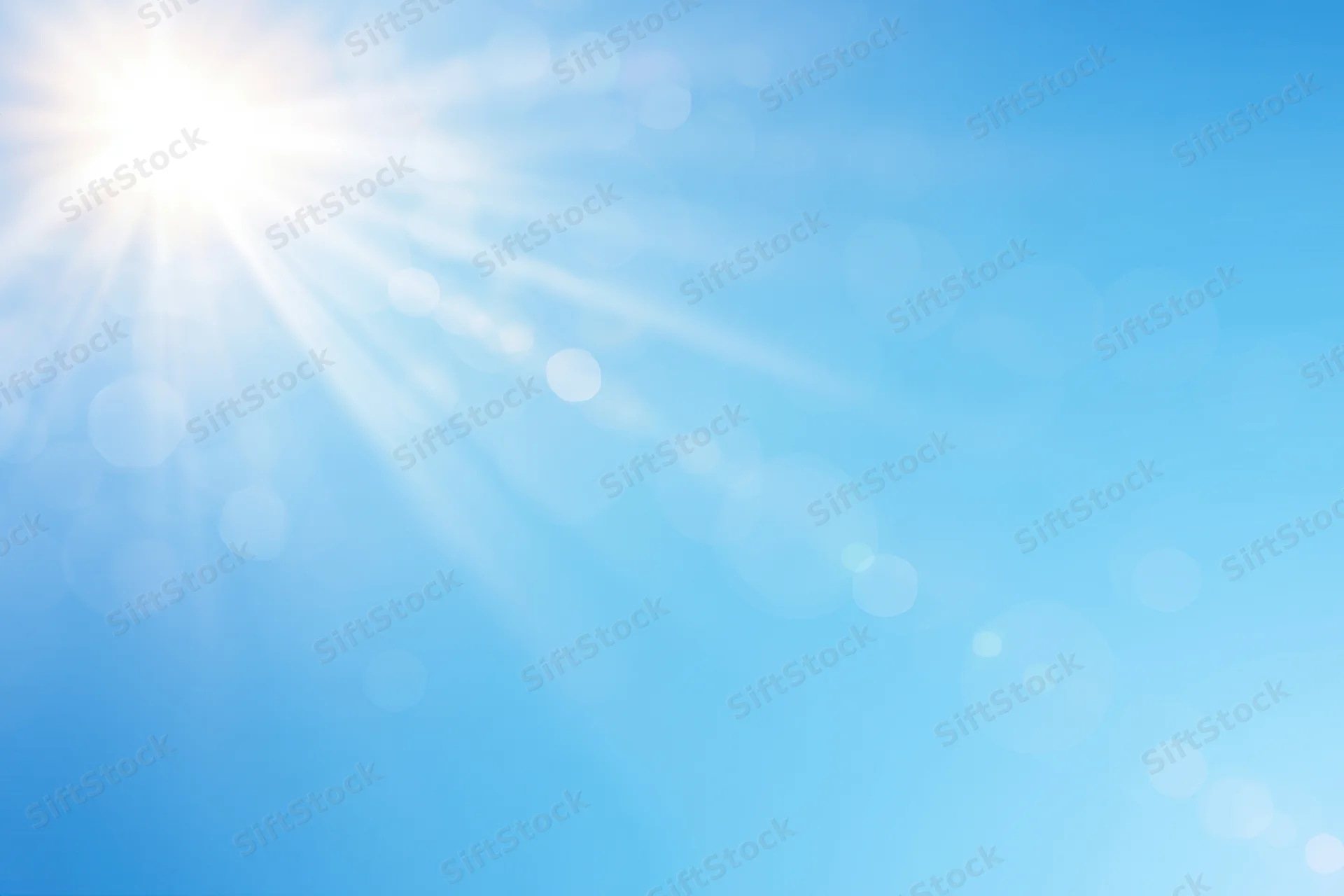 Bright sun with rays and bokeh lights on a blue gradient background