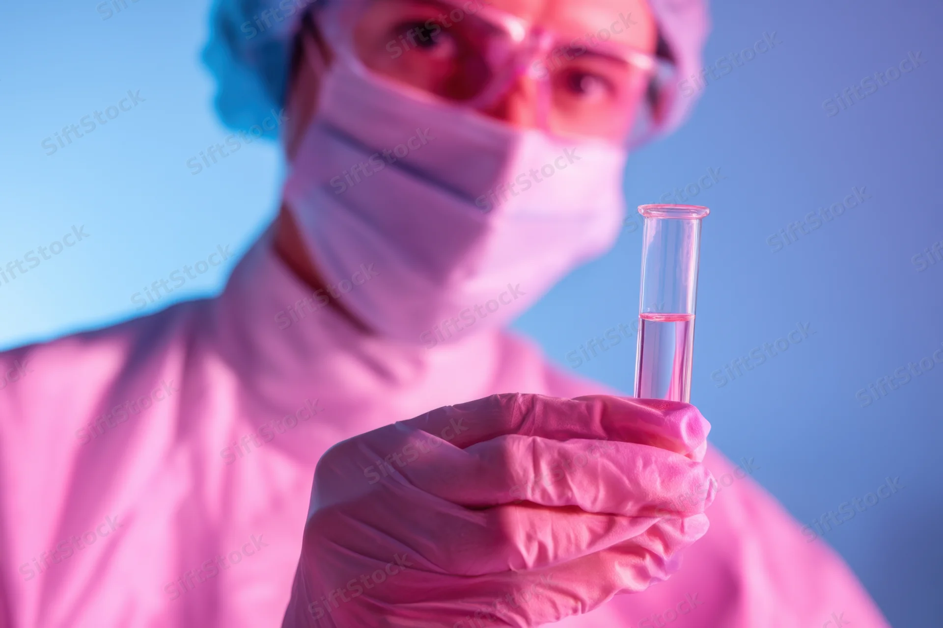 Scientist holding test tube with sample in sterile lab environment