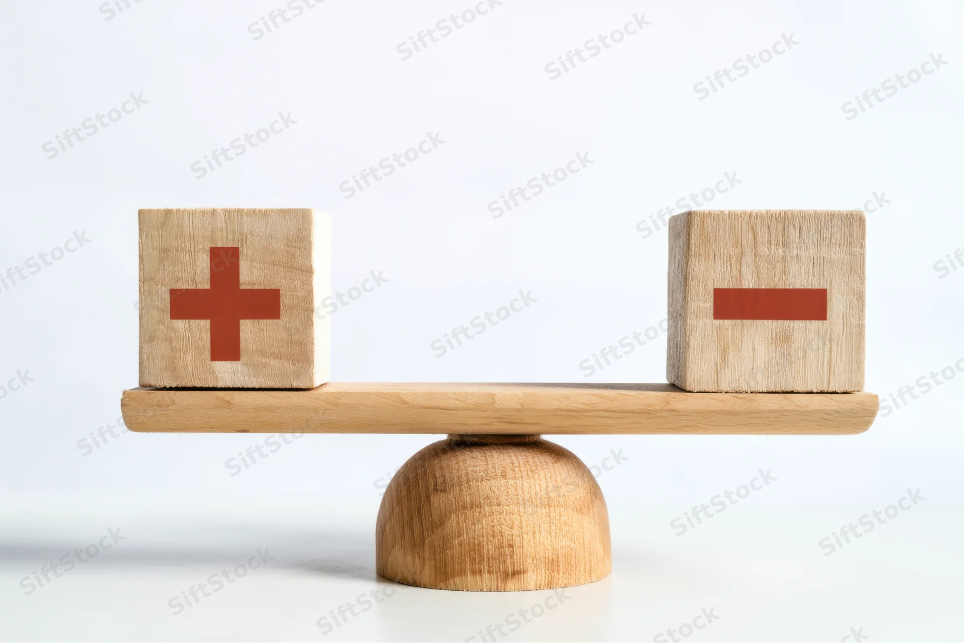 Wooden balance scale with plus and minus cubes on white background
