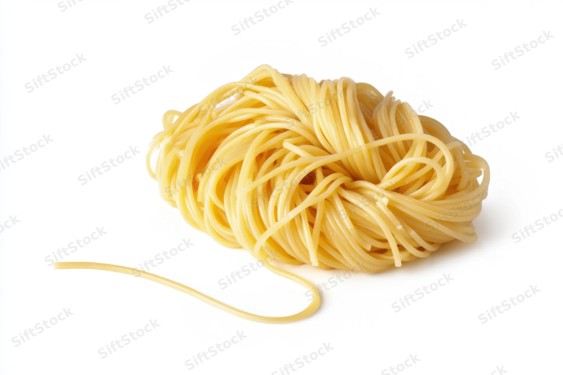 Mound of cooked spaghetti with one strand extending outward on white background