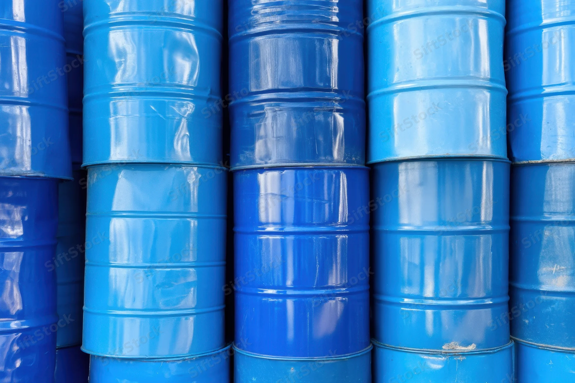 Blue metal barrels stacked vertically in a warehouse storage arrangement