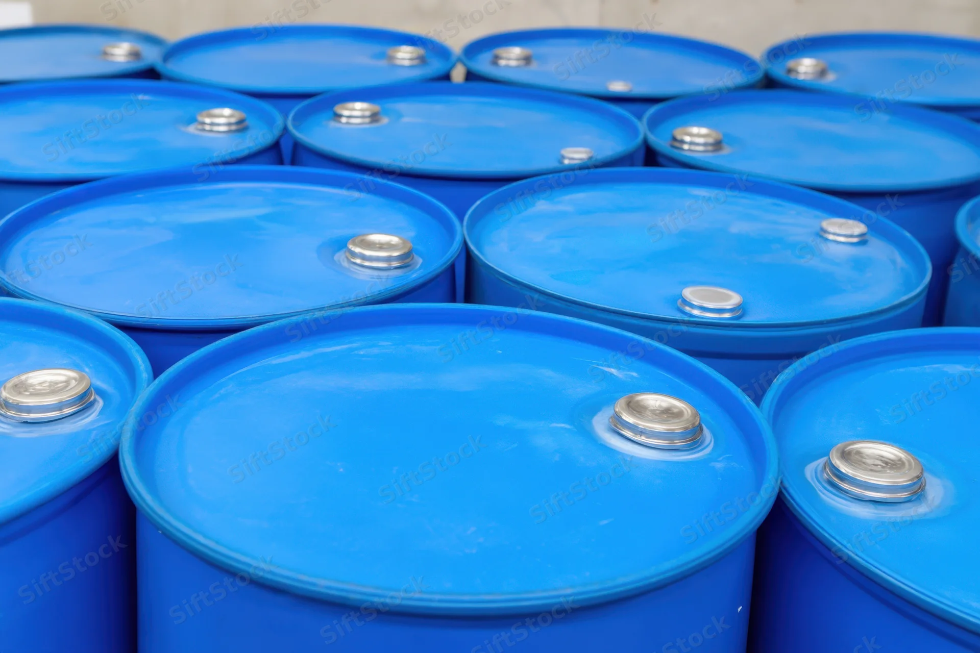 Bright blue plastic barrels stacked neatly in a warehouse storage arrangement