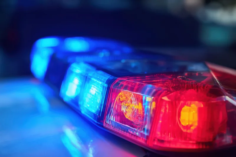 Police lightbar flashing red and blue at night on a patrol vehicle