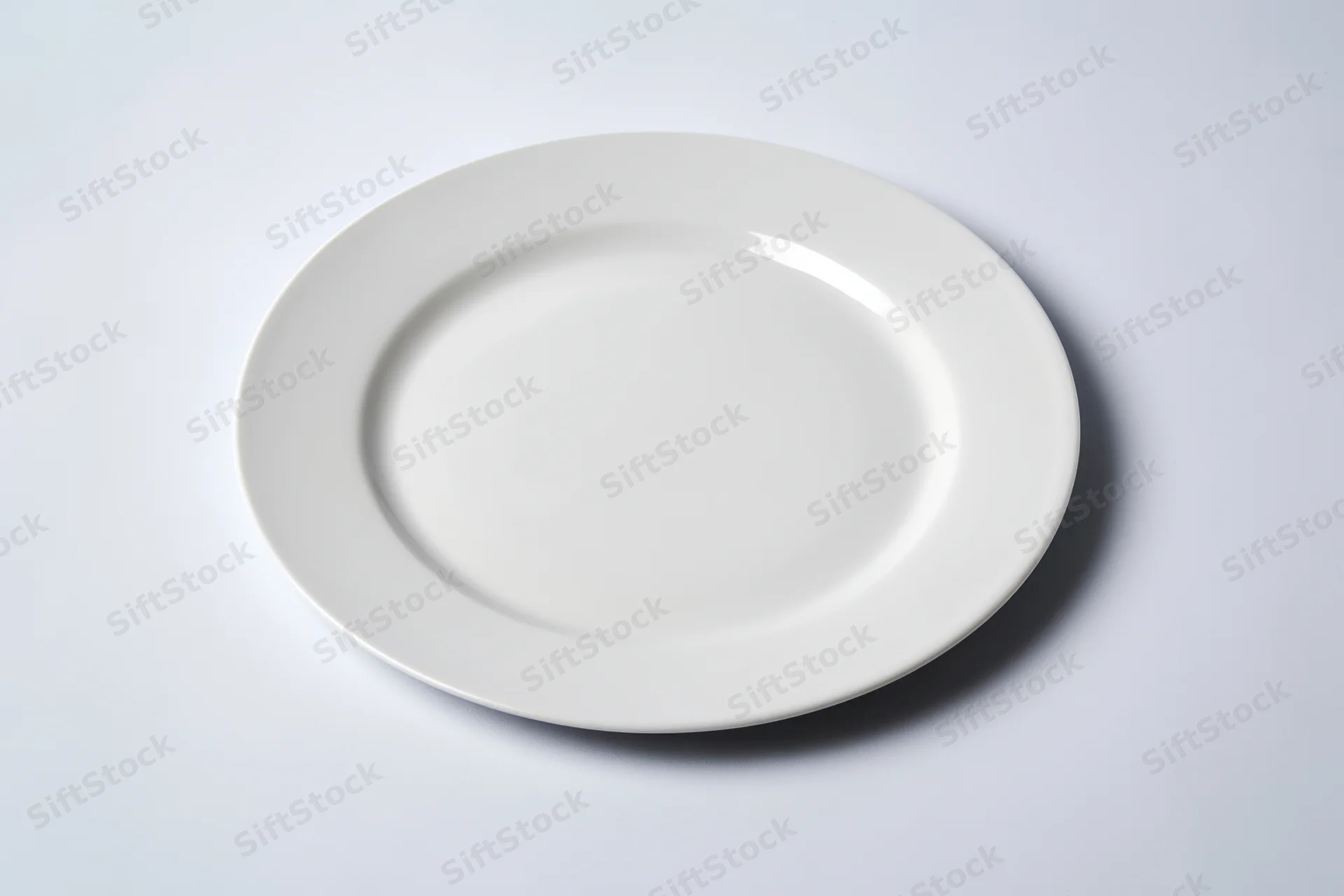 White ceramic plate resting on plain surface with soft shadow and reflection