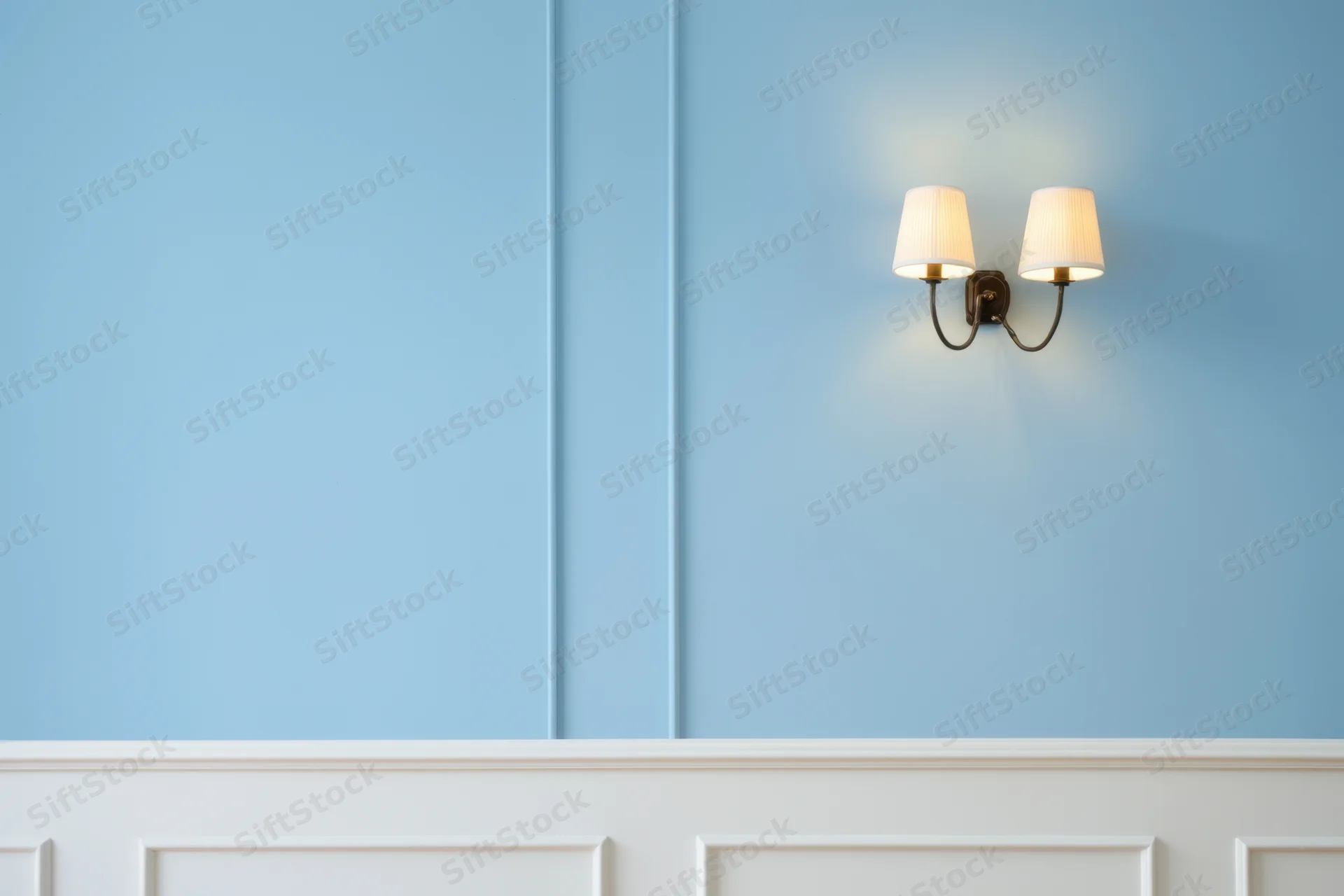 Blue paneled wall with white wainscoting and dual sconce lighting fixture