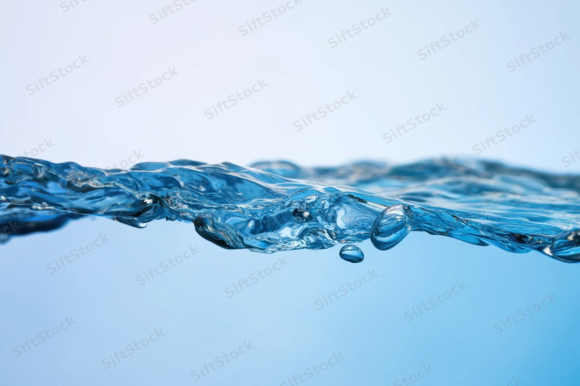 Clear blue water surface with gentle ripples and bubbles against a light blue background