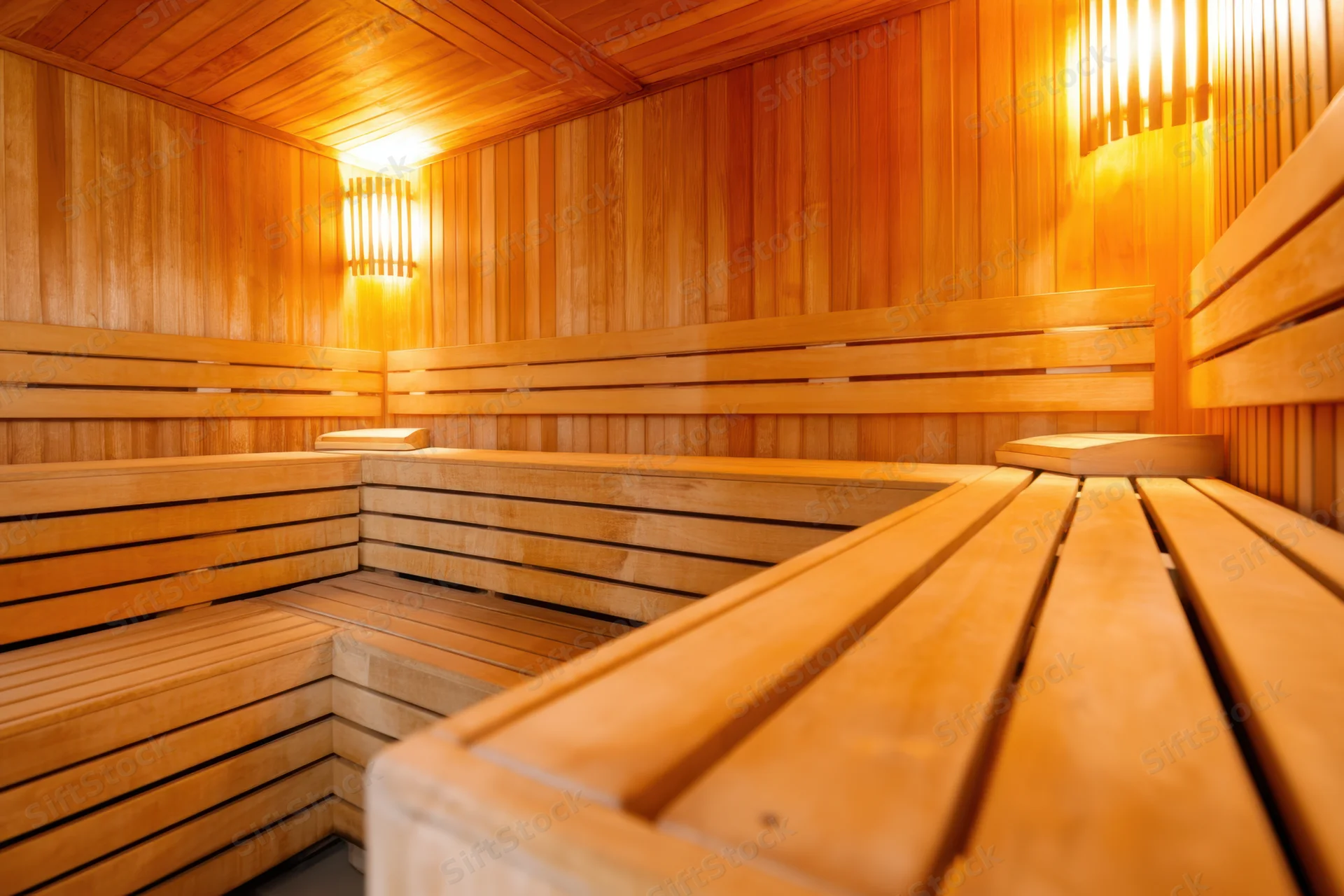 Wooden sauna interior with tiered benches and warm ambient lighting