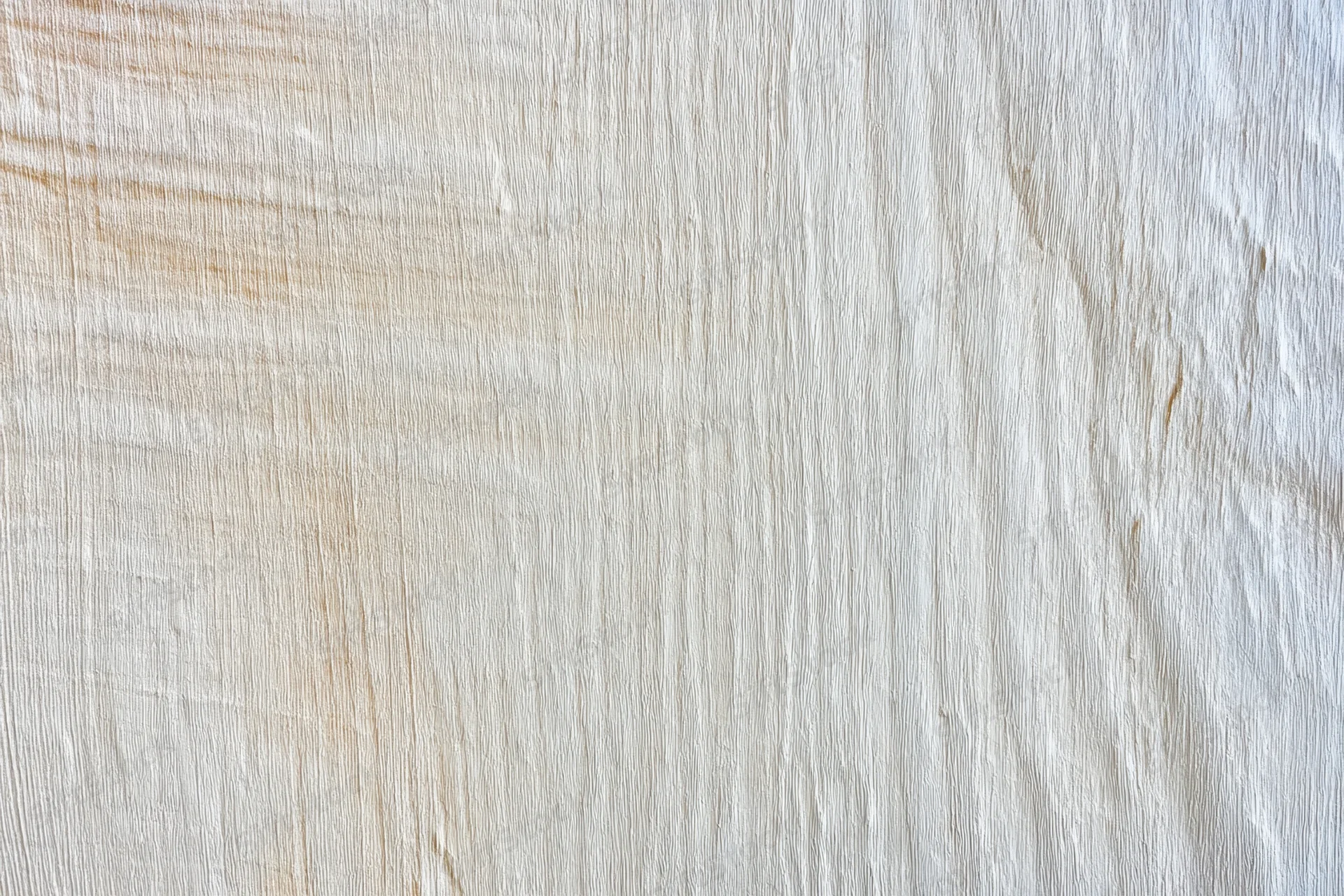 Smooth light weathered wood surface with visible grain pattern filling the frame