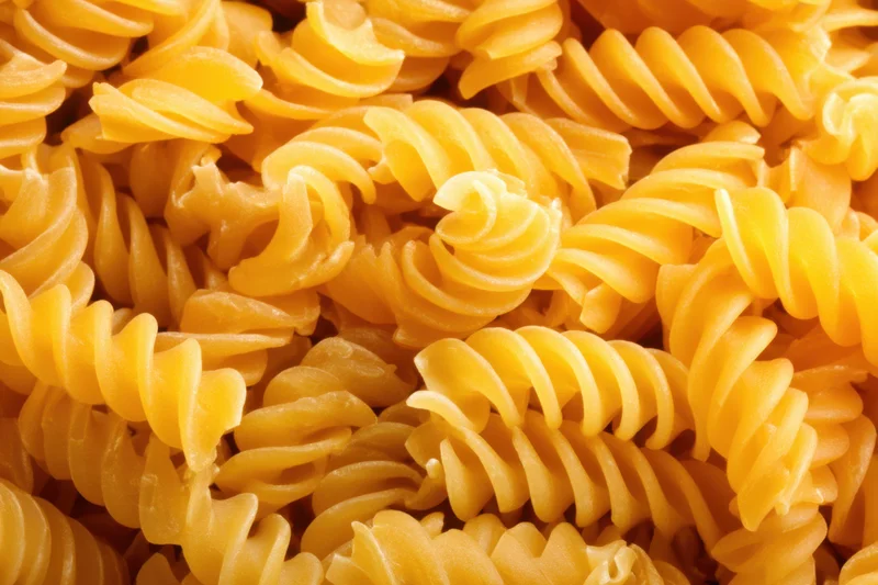 Tightly packed spiral pasta arranged in a dense, vibrant display
