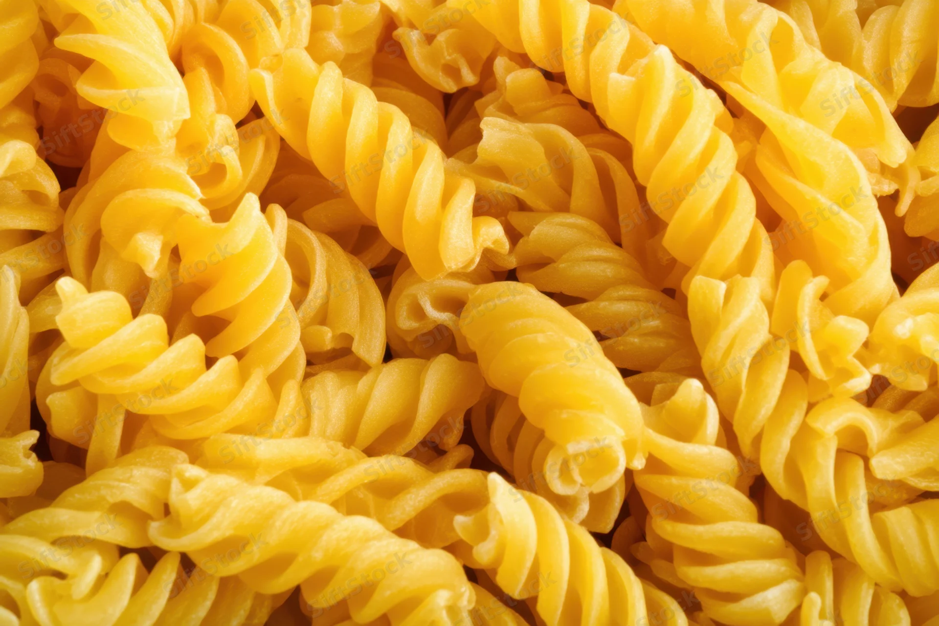 Tightly packed spiral pasta arranged in a close-up view showing texture and detail