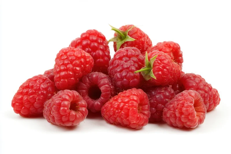 Fresh ripe raspberries scattered artfully against a clean white background