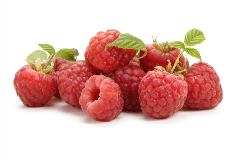 Fresh ripe raspberries with green leaves arranged on a white background