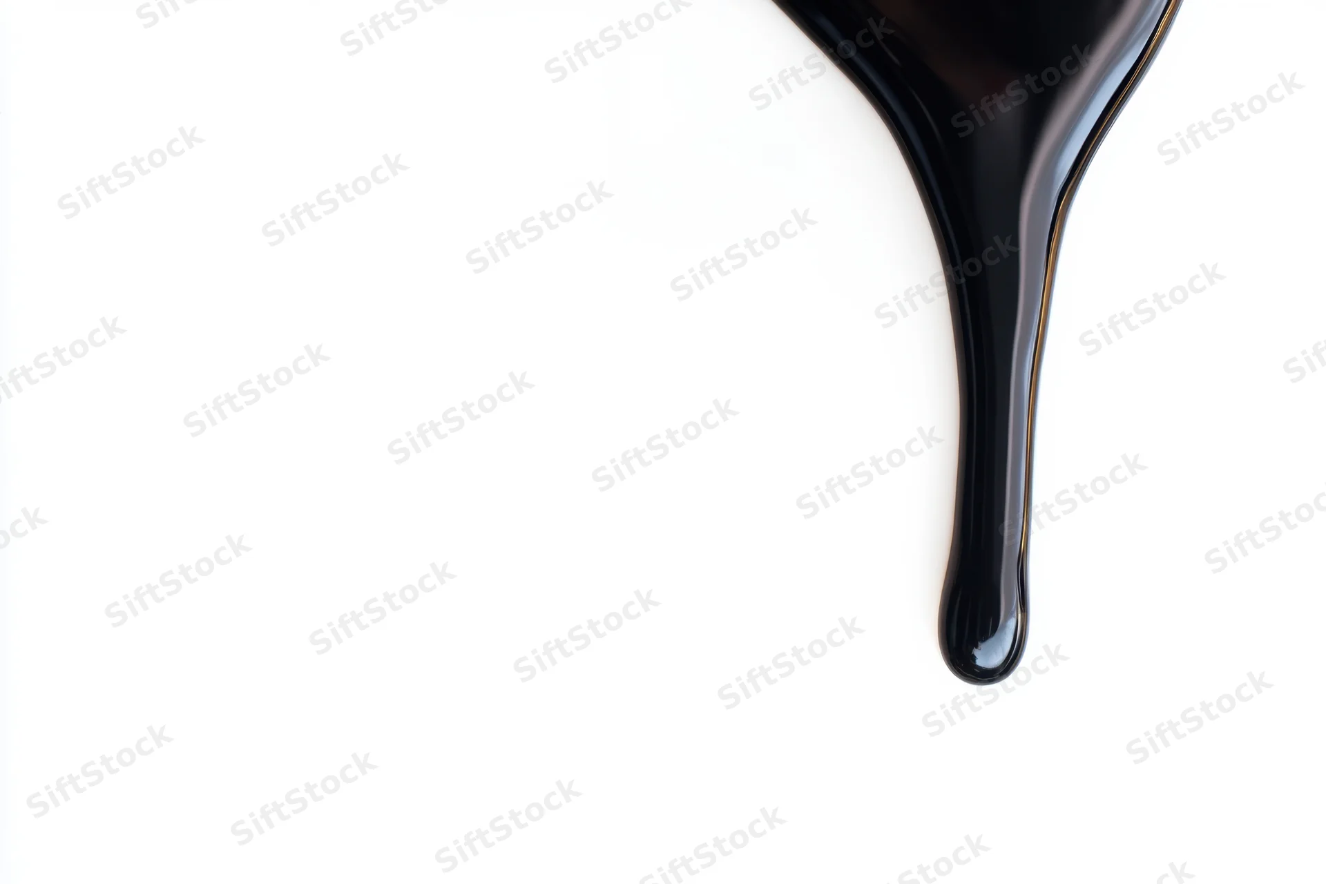 Glossy black paint dripping down against a stark white background