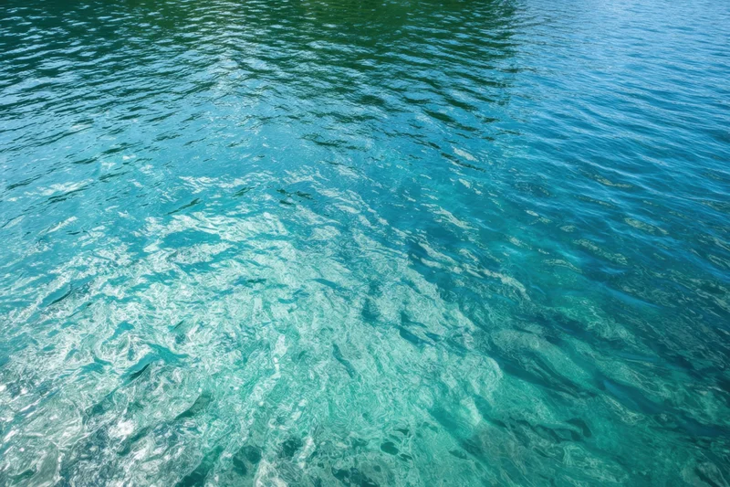Turquoise water with gentle ripples and reflections on the surface