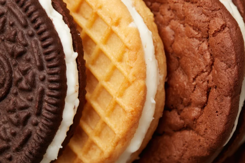 Three types of sandwich cookies arranged side by side in close-up view