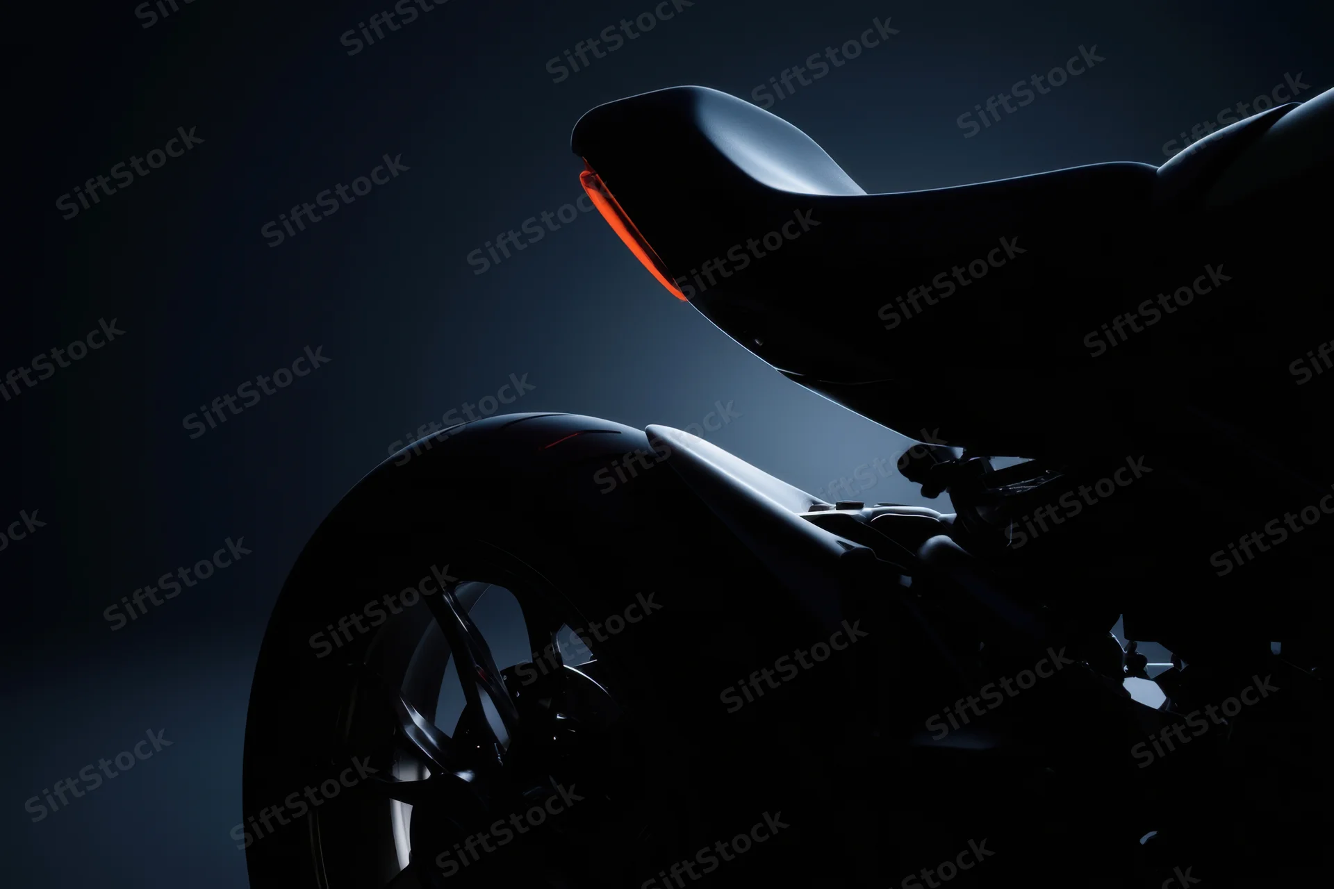Sleek rear profile of a modern motorcycle in dark studio lighting with red tail light illuminated