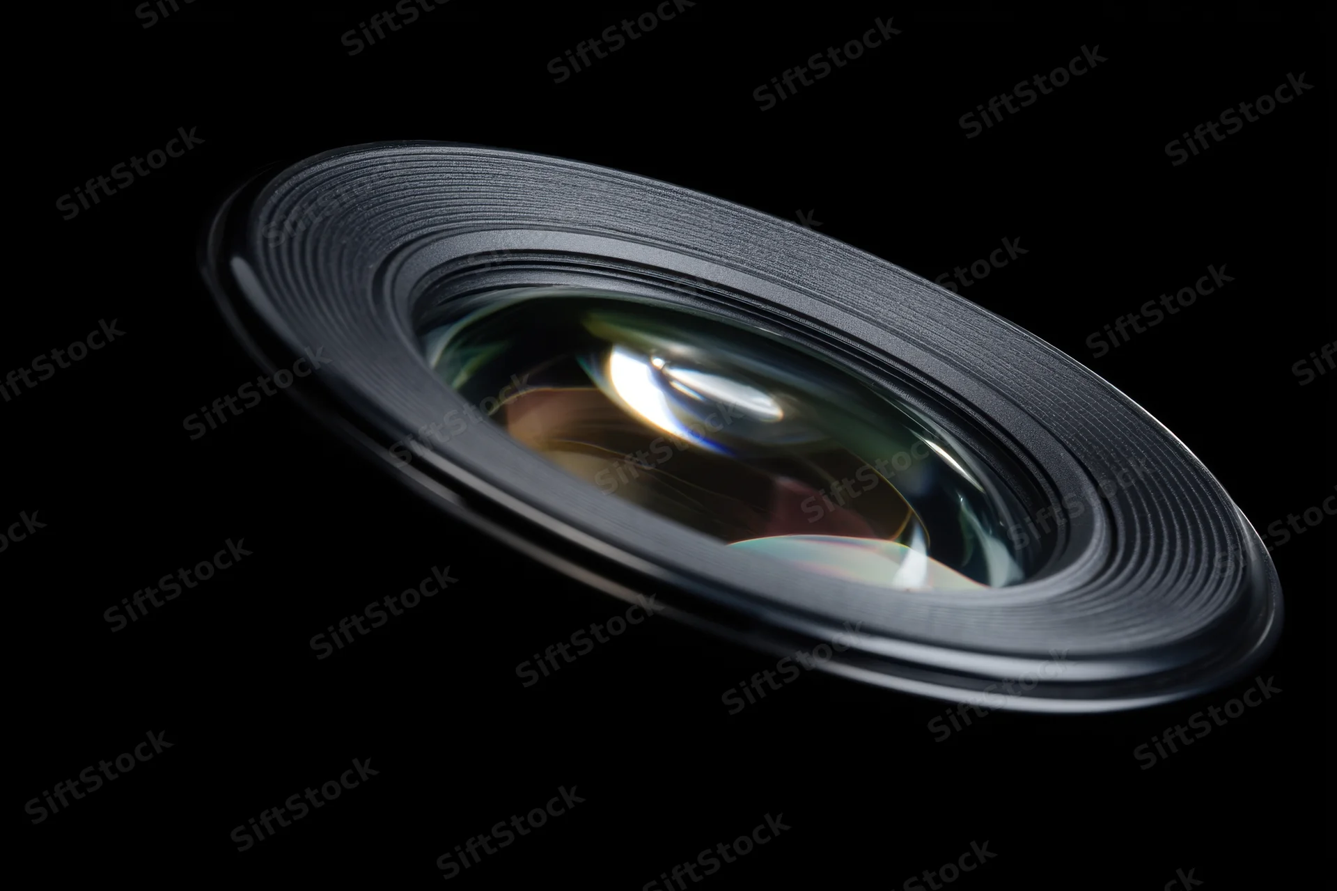 Camera lens with detailed glass elements and ridged metallic rim against black background