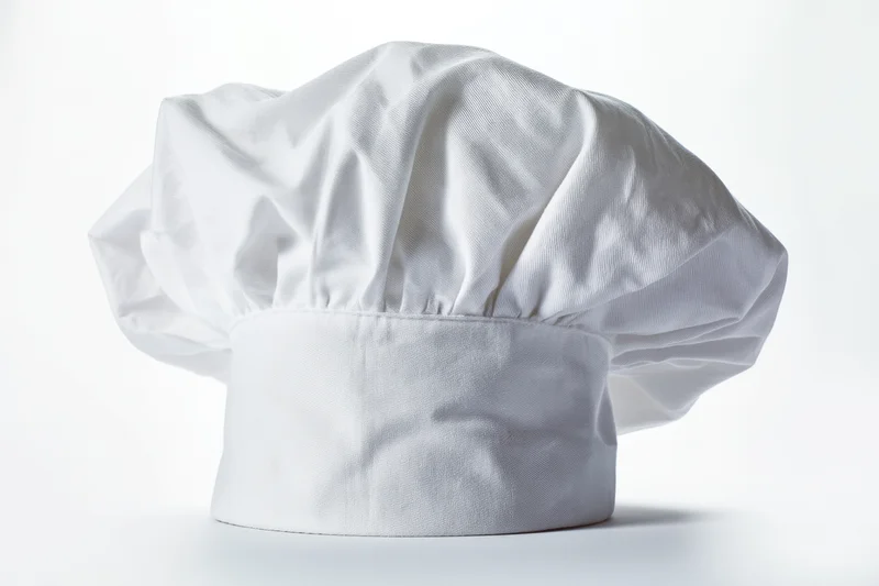White chef hat made of soft fabric displayed on plain white background