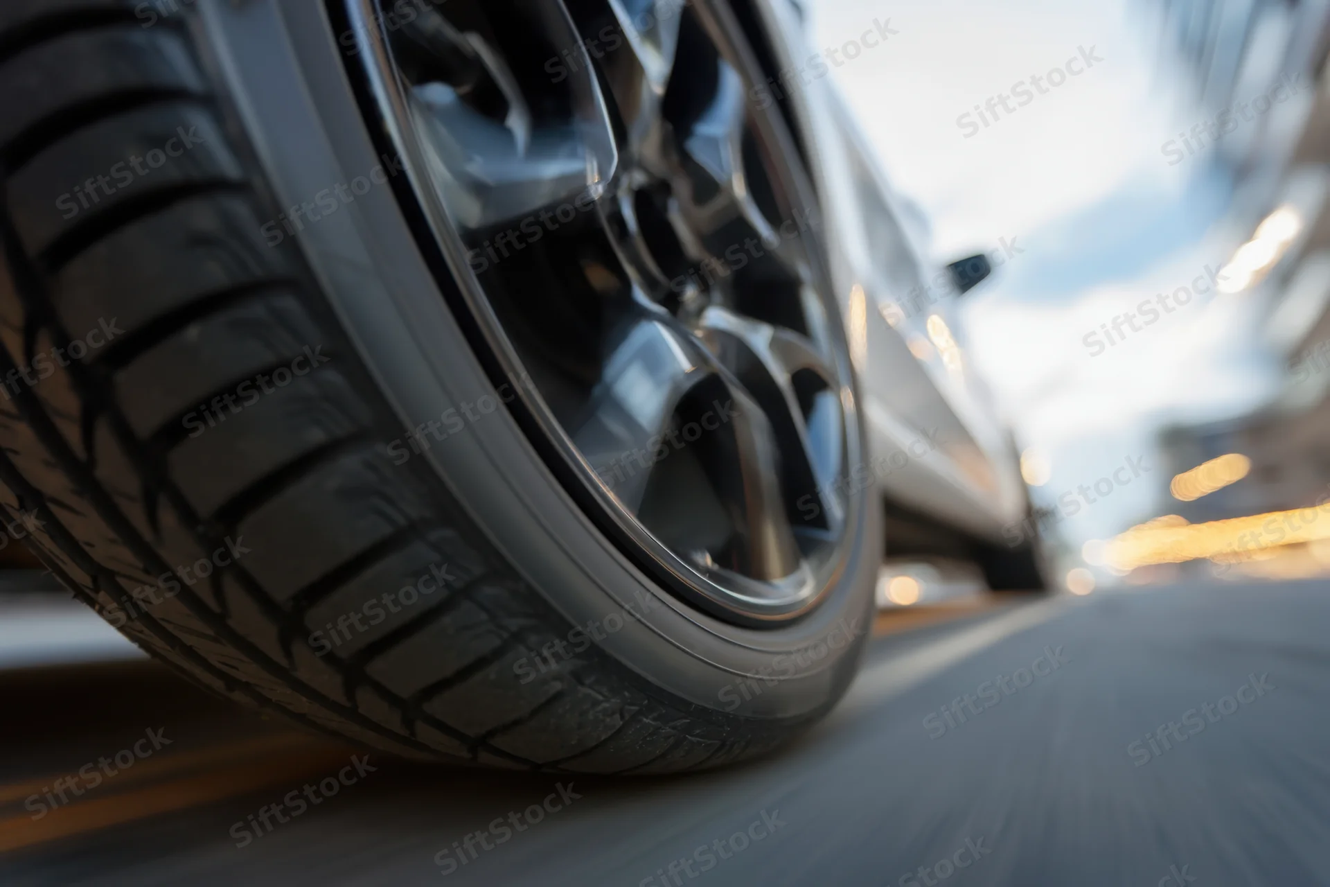 Close-up of a car tire in motion on an urban road