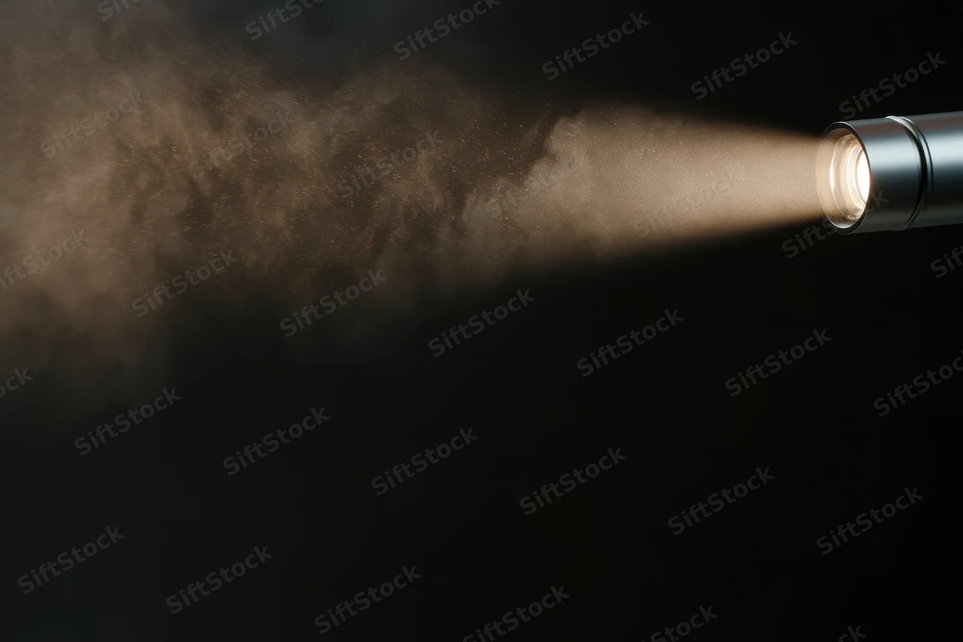 Studio spotlight casting a focused beam of light through smoke in a dark environment