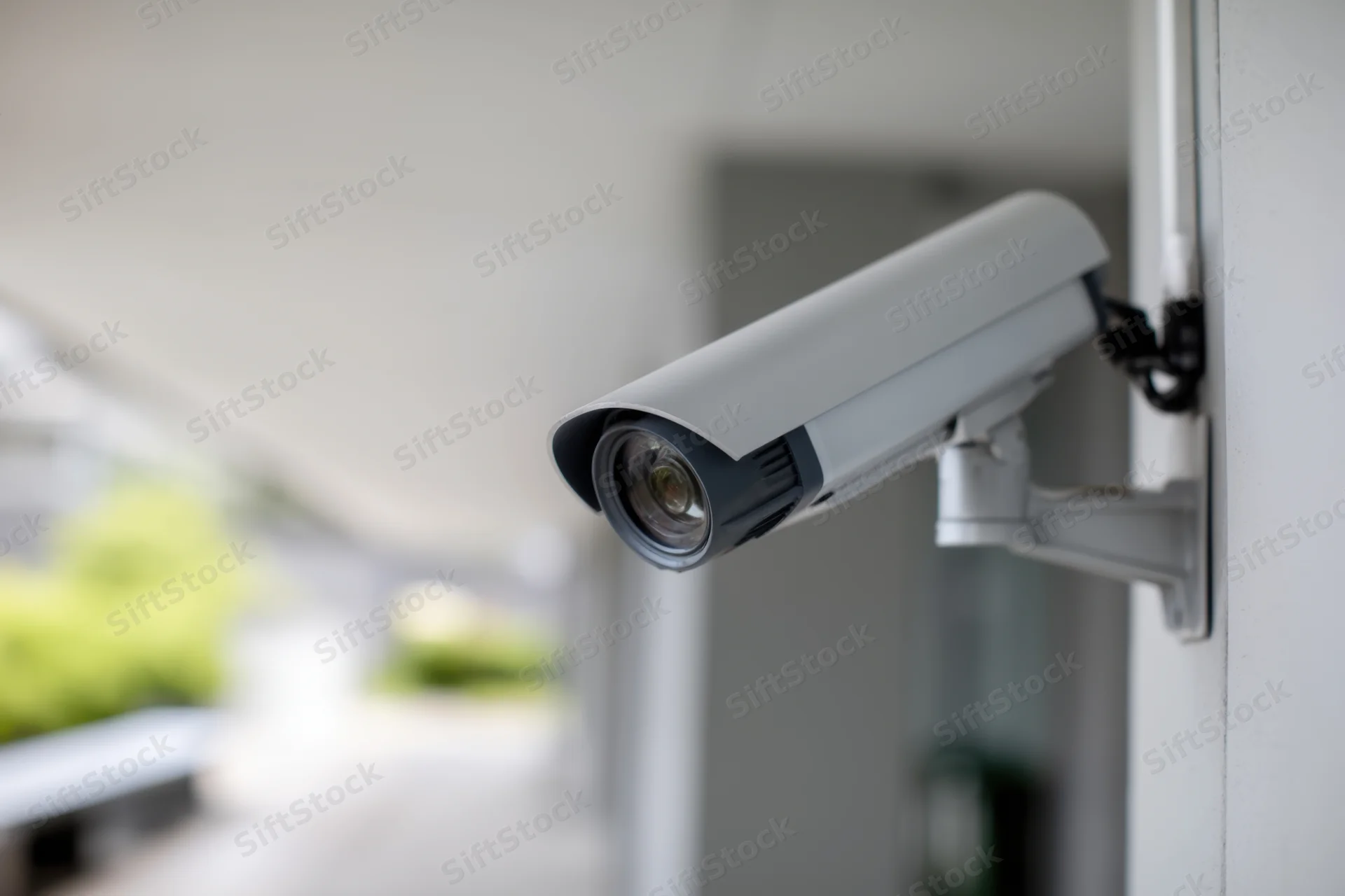 Security camera mounted on exterior wall of building