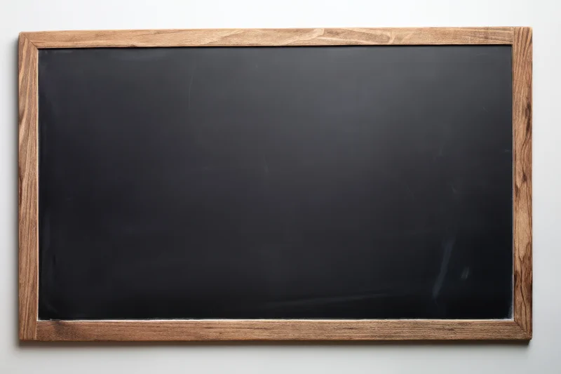 Vintage black chalkboard with distressed wooden frame mounted on a white wall