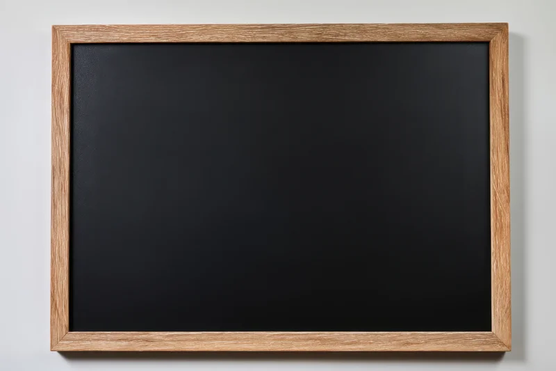 Vintage black chalkboard with distressed wooden frame hanging on a wall