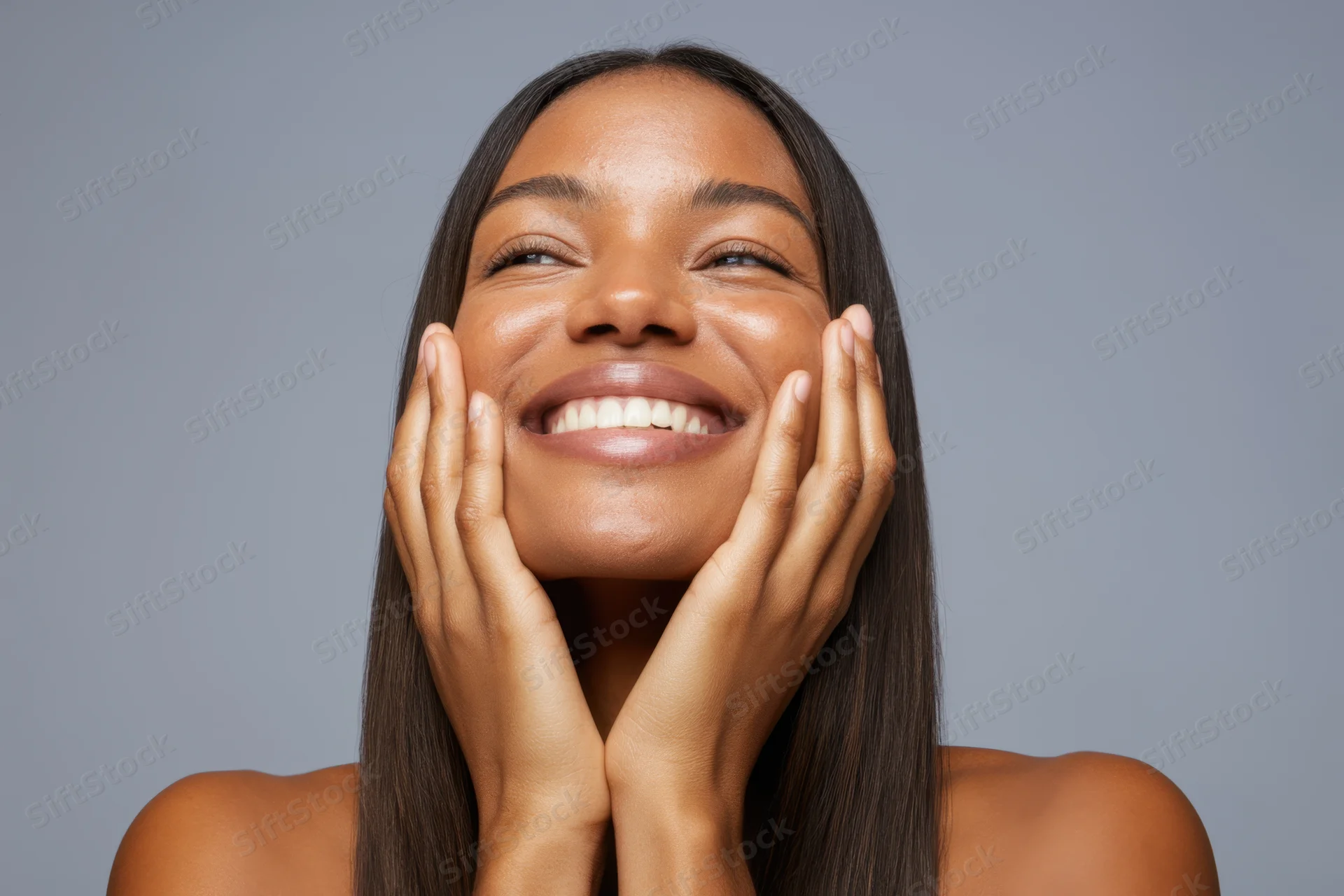 Woman smiling with hands on cheeks, long straight dark brown hair, studio portrait