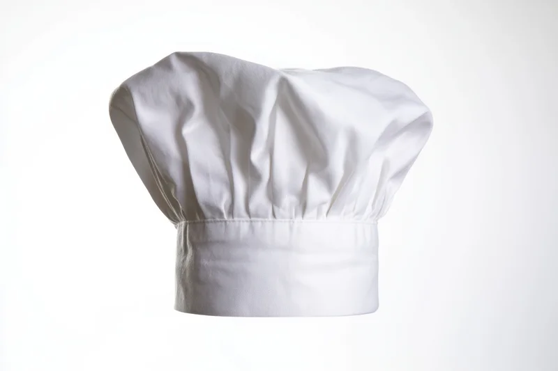 White chef's hat with soft pleated fabric isolated on white background