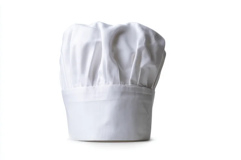 White pleated chef hat isolated on plain background