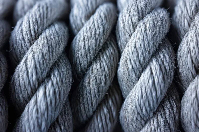 Close-up of thick twisted rope strands braided together in a dense pattern