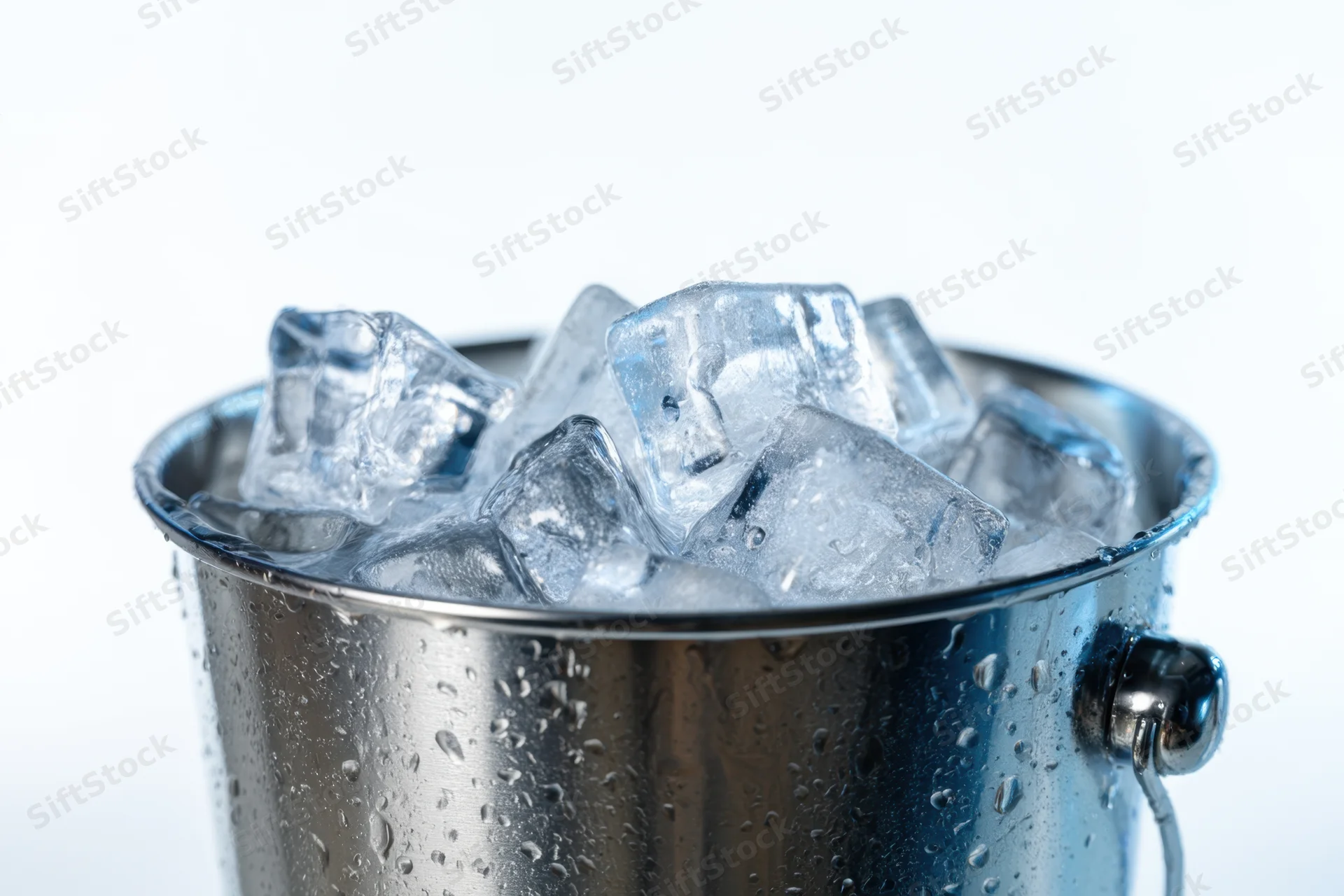 Stainless steel bucket filled with clear ice cubes, condensation on surface, isolated on white background