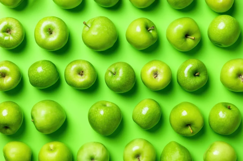 Green apples arranged in a seamless repeating pattern on a bright green surface