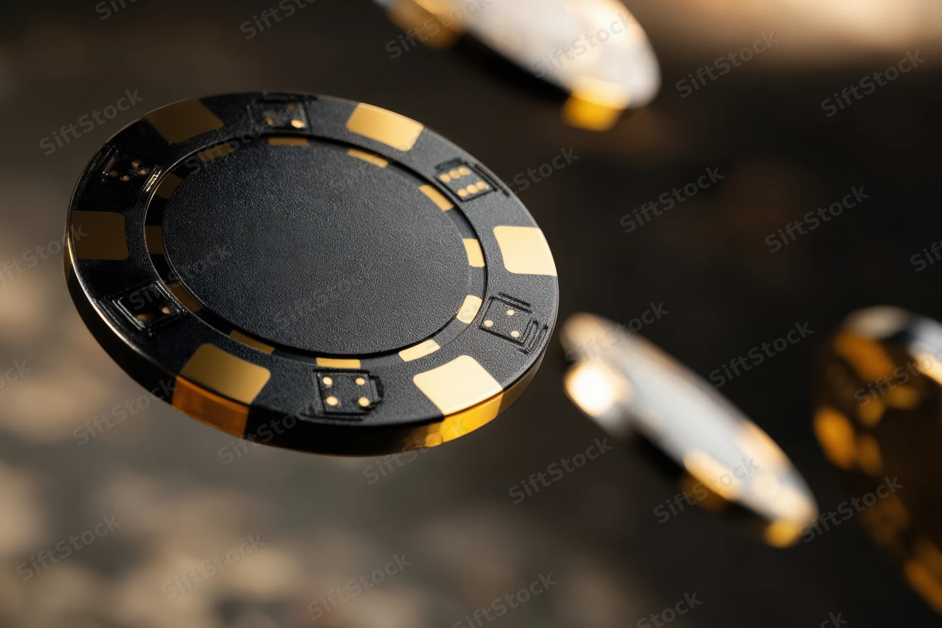 Black and gold poker chips in motion over a glossy reflective surface