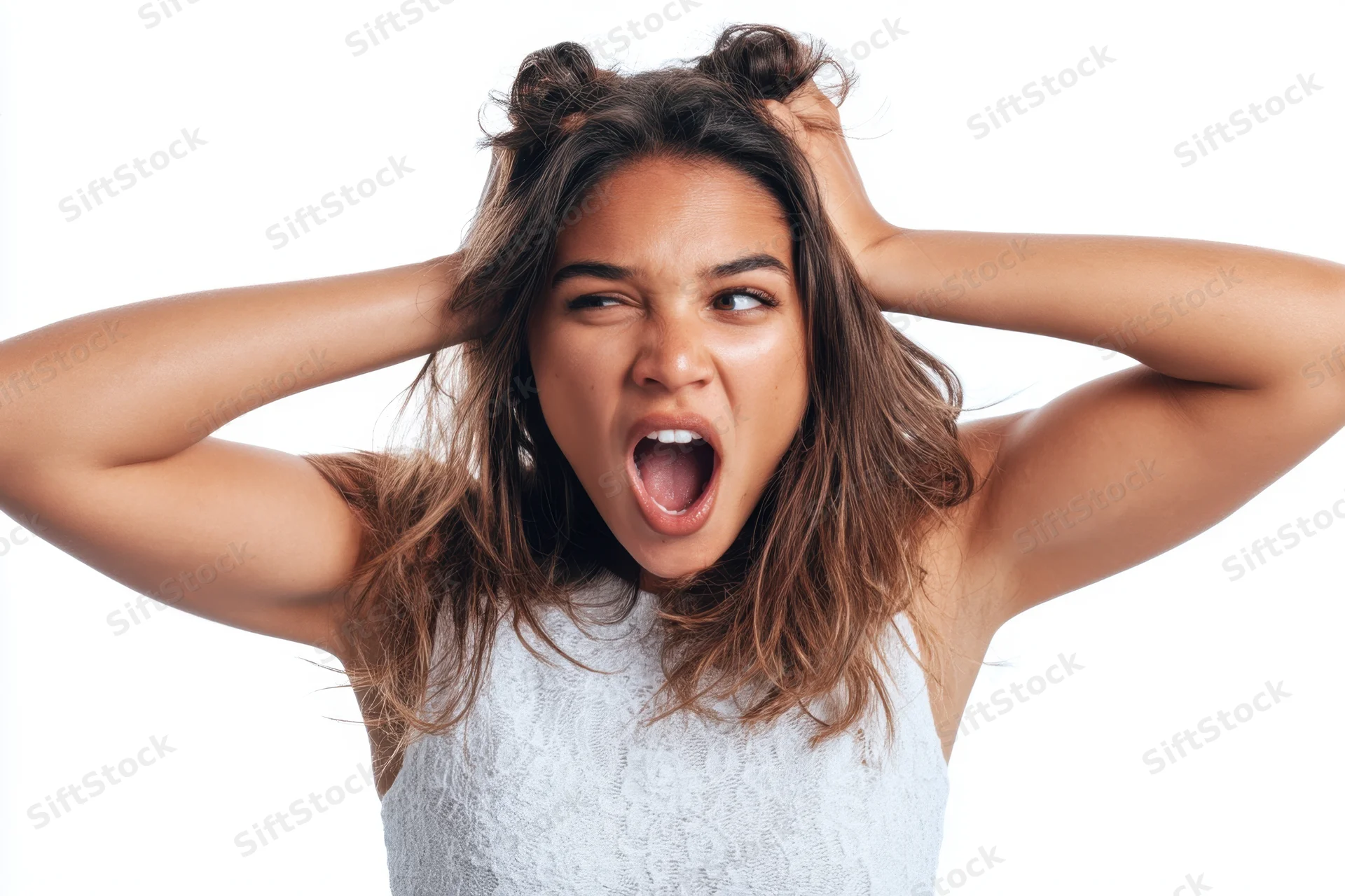 Young hispanic woman shouting with hands in her hair against white background