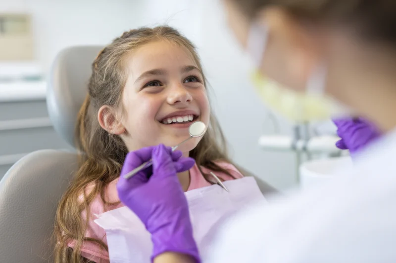 Young girl smiling during dental examination in a dental clinic