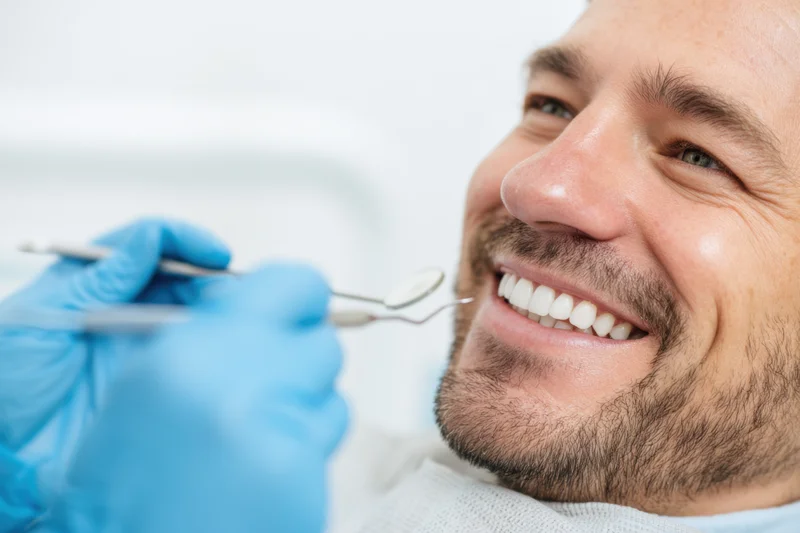 Man smiling during dental examination in clinic