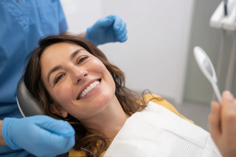 Woman smiling in dental chair during examination by dentist