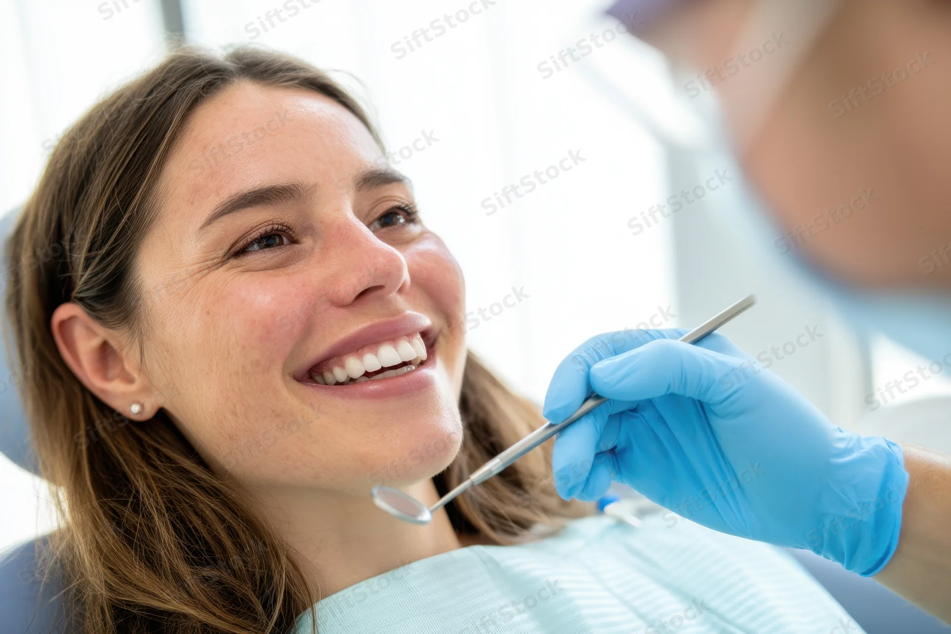 Smiling woman reclining during dental examination in clinic