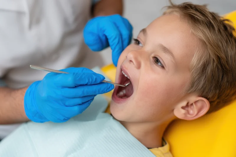 Young boy undergoing dental examination in a clinic chair