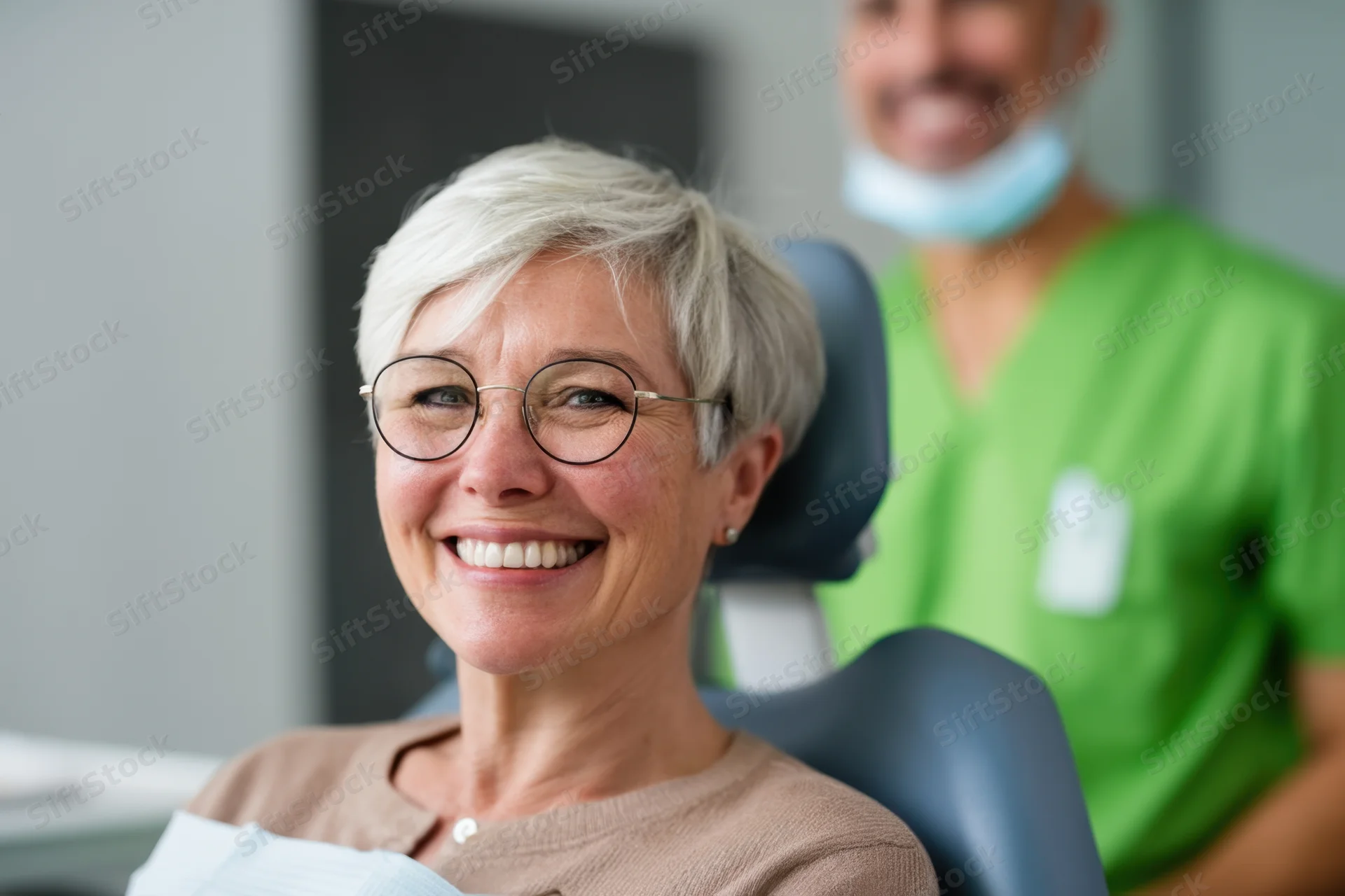 Smiling woman in dental chair with dentist in background