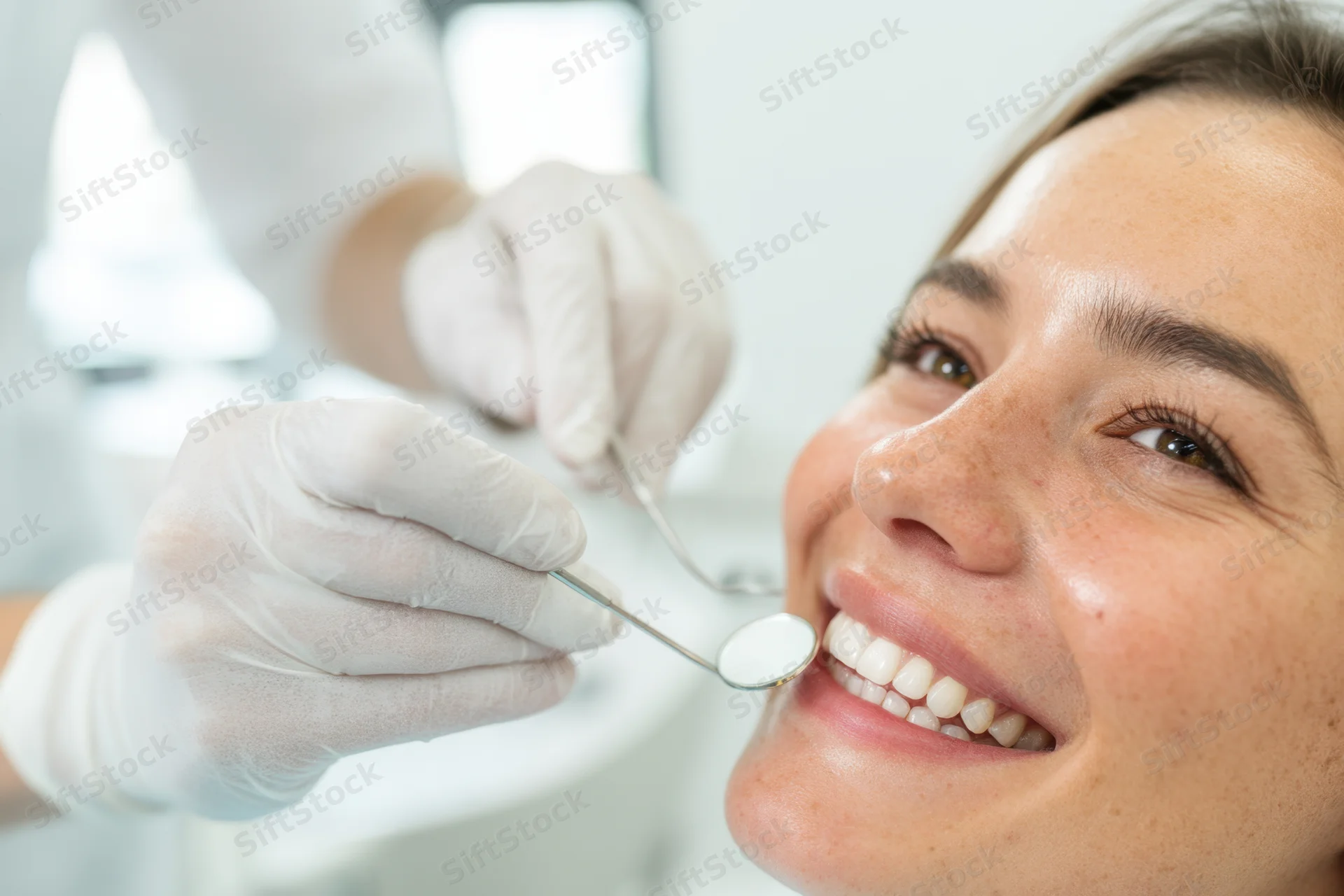 Woman smiling during dental examination in clinic