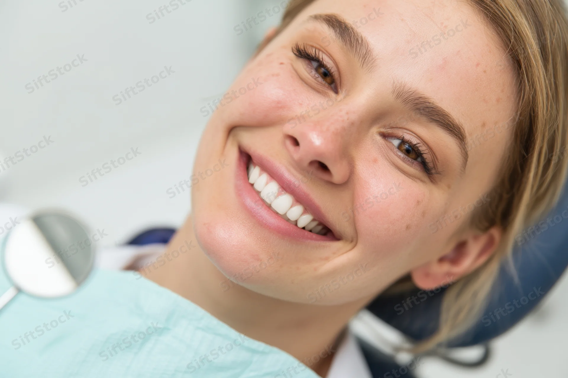 Woman smiling in dental chair during examination