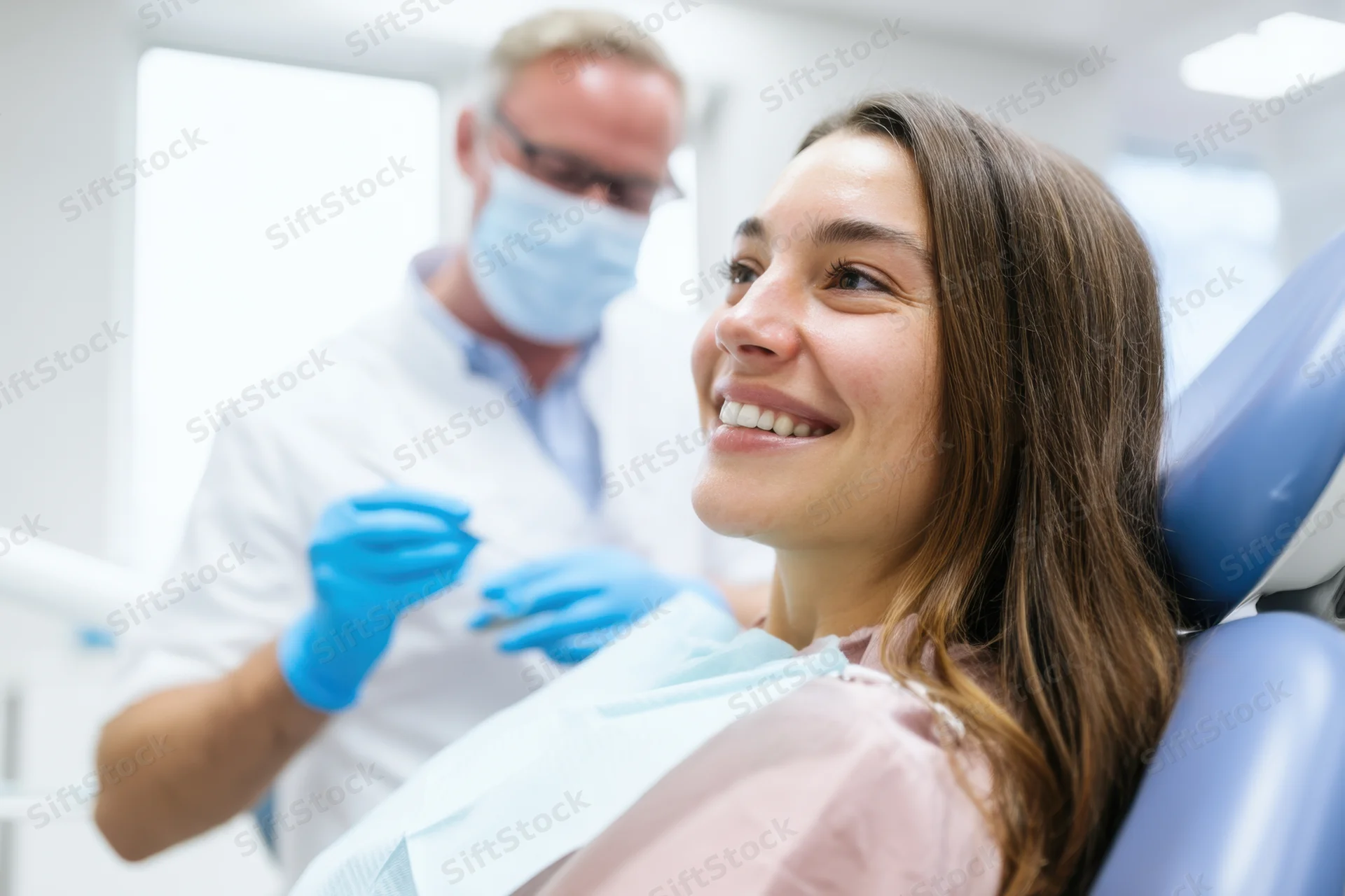 Woman smiling in dental chair during examination by dentist
