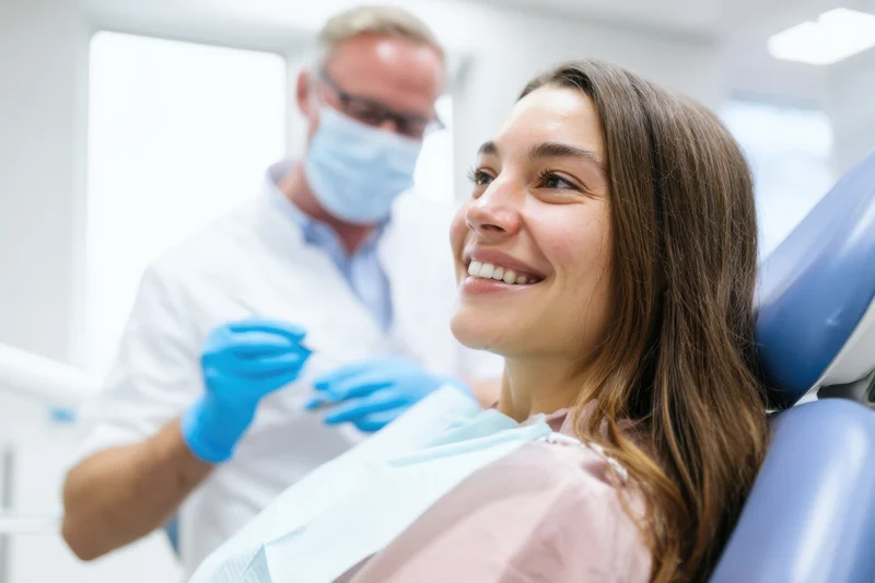 Woman smiling in dental chair during examination by dentist