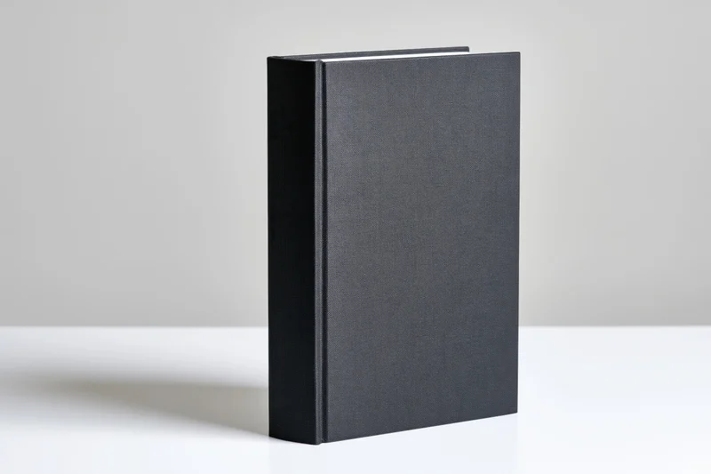 Black hardcover book standing upright on white surface