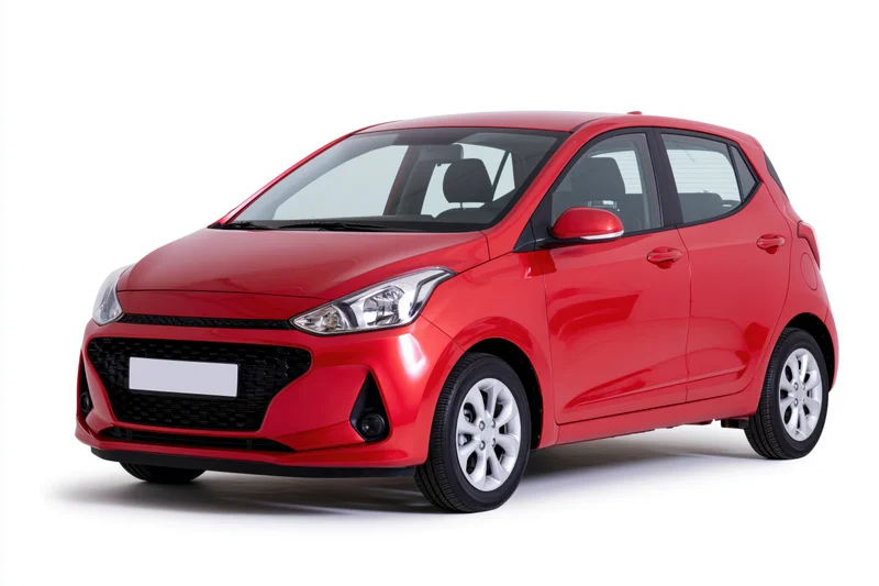 Red compact hatchback car parked in studio with white background